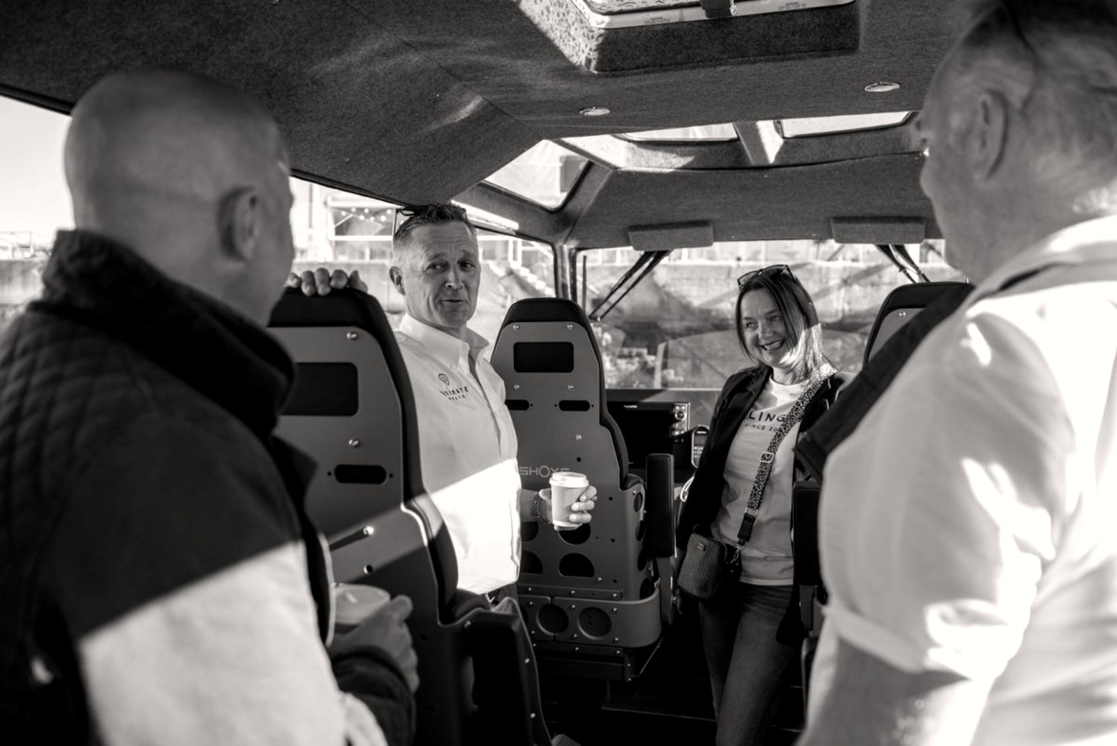 Jason Purvey talking with customers aboard a boat at a demonstration