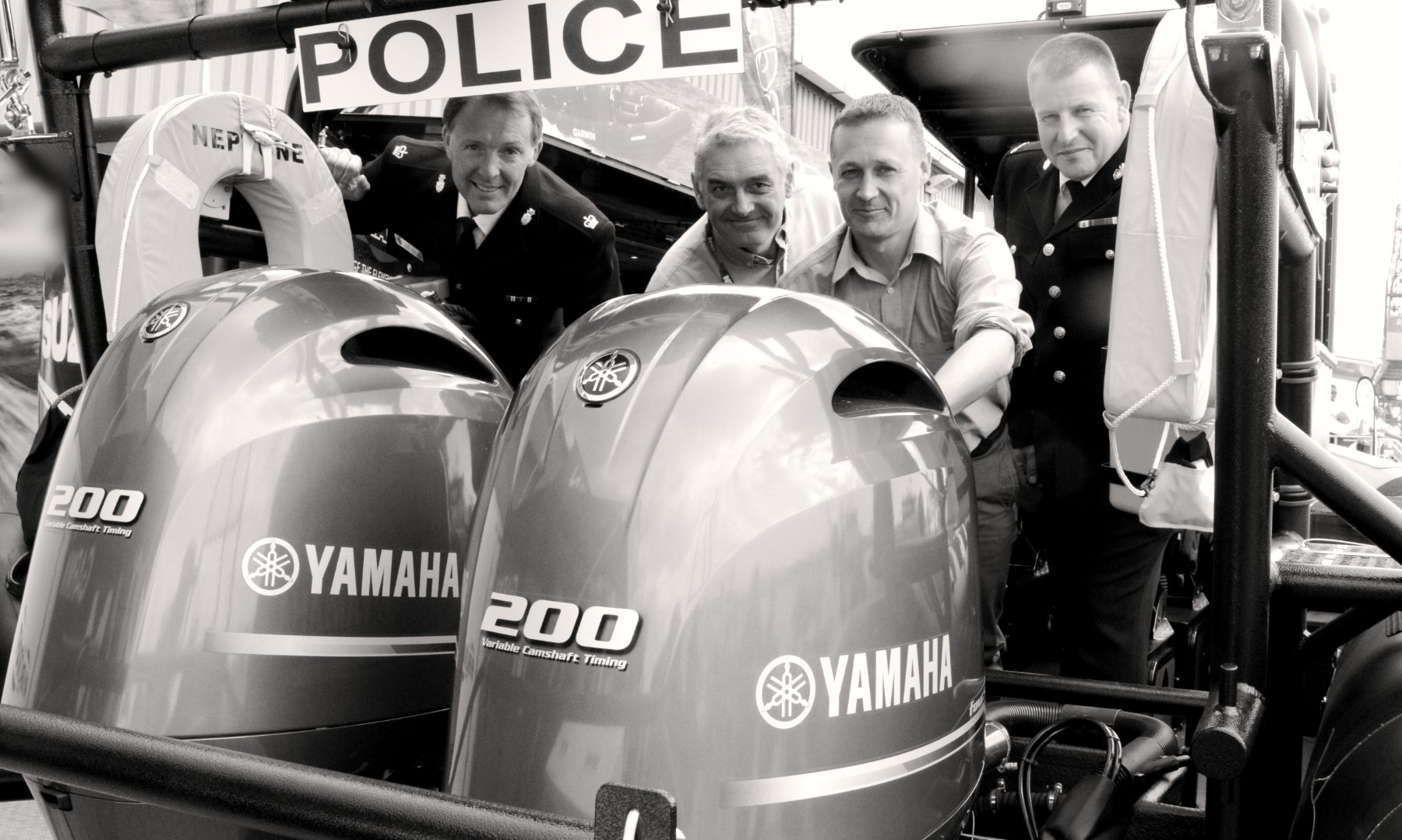 Jason Purvey with police officers and colleagues aboard a new police patrol boat